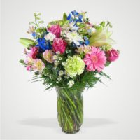 Mix of Blues Pinks and White Delphiniums Gerberas Roses Carnations and Greens in a Vase