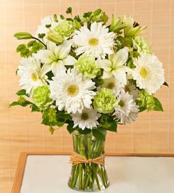 while lilies gerberas green in vase