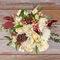 white roses and flowers with fir cones wrapped